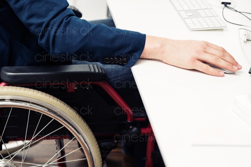  Detailansicht von Rollstuhlfahrer an Schreibtisch 20150510-0118 