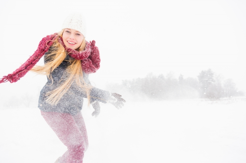 Blonde Frau wirft mit Schnee 20130117