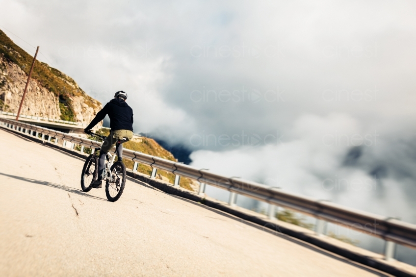 Mann auf Mountainbike Rückenansicht aus Distanz 20150817-0308